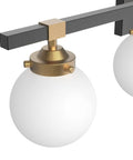 Close-up of Four Light Mid Century Modern Bathroom Vanity Light Fixtures Over Mirror In Black And Gold With Milk White Glass Globes