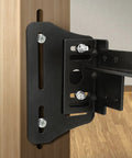 Close-up of Premium Universal Bed Frame Brackets And Headboard Connectors Black 2 Piece Steel Plates mounted on wood post.