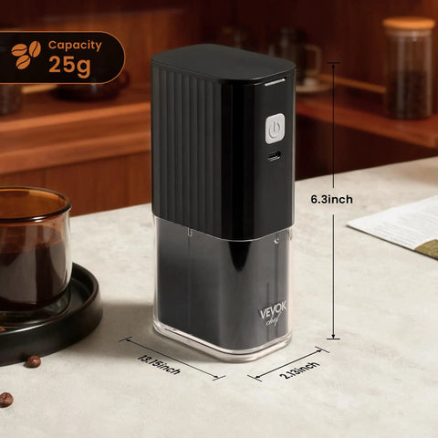 Road Trip Ready Portable Electric Coffee Grinder With Adjustable Stainless Steel Burrs, USB Rechargeable One Touch Auto Stop, No Sweat Brewing For Espresso To French Press, Collapsible Hopper In Black on a table with coffee.