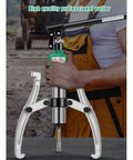 Heavy Duty Hydraulic Gear Puller, 30 Ton Bidirectional Separator Tool, adjustable jaws, held by mechanic for easy bearing removal.