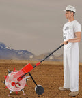 Person using Hand Push Seeder With Six Nozzles For Precise Garden Planting Walk Behind Seed Planter on soil