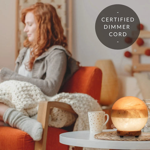 Dual Illumination Himalayan Salt Lamp Round Globe in cozy setting with dimmable glow, pink white gray layers, warm ambiance