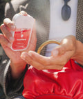 Person using Hydrating Hand Sanitizer Spray Trio Set With Aloe Vera And Essential Oils Featuring Wild Watermelon Velvet Peach Berry Bliss