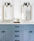 Bathroom scene with vintage industrial double wall sconce in black above mirrors, dual 5.9 inch clear glass globe shades visible