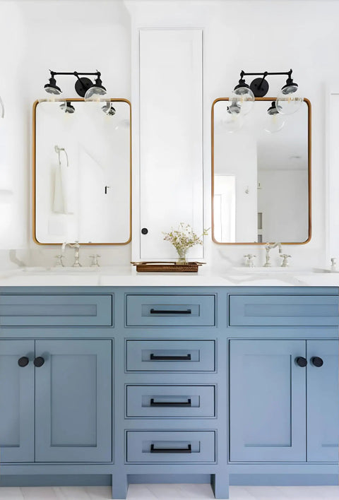 Bathroom scene with vintage industrial double wall sconce in black above mirrors, dual 5.9 inch clear glass globe shades visible