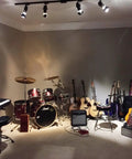 Music studio with drum set, guitars, and Two Pack Dope Industrial Vintage Ceiling Track Lights With Adjustable Spotlight Heads.