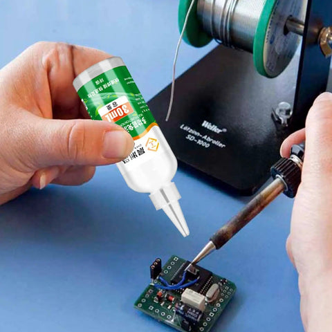 Person using Pro Grade Aluminum Soldering Flux Liquid for Quick Dry Welds Colorless Stainless Steel Flux Paste in electronics work.