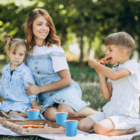 Family picnic with blue sturdy 5oz disposable paper cups, 1200 pack ideal for cold drinks, parties, events, and snacks outdoors.