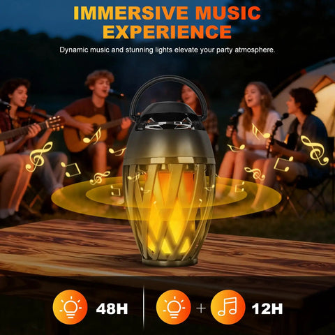 Flame Lamp Speaker With Multicolor Lights For Outdoors Patio Pool Camping Waterproof Torch Lantern 7 Lighting Modes And Music Sync RGB Glow, placed on table, with group enjoying a campfire vibe in the background.