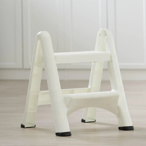 Two Step Folding Foot Stool, 14 Inch High, 300 Pound Capacity, Grab And Go Lightweight, Rust And Dent Resistant With Four Skid Resistant Feet, Ideal For Kitchen, Bathroom, Garage, Closet, Library And More in white on light wood floor.