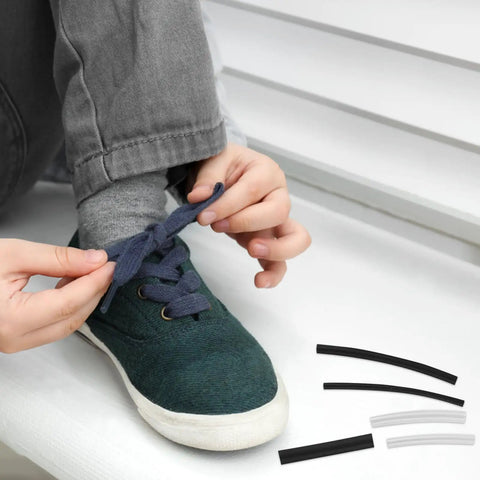 Fix Tired Laces Fast With This 78 Pc Shoelace Repair Kit Featuring Heat Shrink Caps And End Tips For Casual Sneakers Or Dress Shoes To Shorten Ends And Rejuvenate Your Kicks Anytime. person tightening shoelace on green sneaker with shrink caps