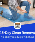 Blue Self Adhesive Floor Protection Film For Moving And Construction Projects being applied on hardwood floor by man