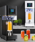 Commercial Grade Vacuum Cup Sealer With LCD Counter And Adjustable Heat Dial, black and white units sealing drinks on a countertop.