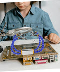 Child using Multifunction Soldering Station And Welding Table Stand With Arms And Base Portable Helping Hands Tool