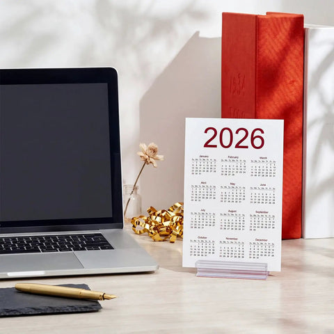 25 Pack Adhesive Base Sign Holders With Strong Backing For Counters And Shelves, Multipurpose Sign Displays For Restaurants, Retail And Warehouses, Easy Peel And Stick, 1 By 3 Inch, clear holder on desk with 2026 calendar card