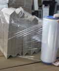 Heavy Duty 12 Inch Stretch Film With Insane Clarity Smooth Glide Self Adhering Shrink Wrap For Moving And Pallets 1000 Feet Of Clear Packing Material used on stacked cardboard boxes.
