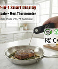 2-in-1 smart display scale and meat thermometer in use with steak on stovetop pan.