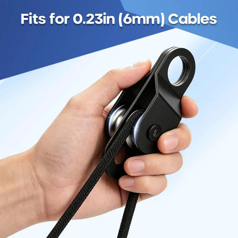 2 Pack Black Pulley Block System Ready To Rig With 4 Double Pulleys, 16 Ft One Quarter Inch Nylon Rope, 4 M6 Spring Hooks, And 2 M6 Eye Pad Plates For Gate Replacement, Farm Use, Garage Lift, And Heavy Duty Rigging. Hand holding black pulley block for 0.23in (6mm) cable.