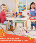 Two children playing indoors with toys, including a Bug Bungalow Insect Catching Kit For Kids With Mesh Case Magnifying Container Tweezers And Magnifier An Educational Outdoor Nature Exploration Toy For Toddlers And 3 Plus Years Totally Fun held by a girl.