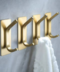 Brushed Gold Self Adhesive Wall Hooks Four Pack Stainless Steel Towel Coat Hat Robe Hangers For Bathroom And Kitchen No Drill Easy Install Rustproof Strong Hold In Wet Environments mounted on wall