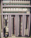 Interior of a control panel showing complex wiring system and components with a Cabinet Door Support Arm Stop Hinge visible.