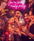 Lit Pink Neon Sign Youre Like Really Pretty Wall Decor LED Light Up Sign at a party with smiling people and confetti