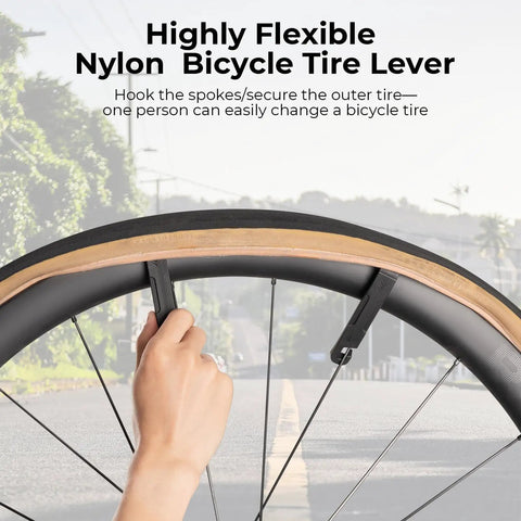Person using tire lever on bike wheel, Portable Bike Multitool With 7 Magnetic Bits, Ratchet Wrench And CO2 Inflator Nozzle