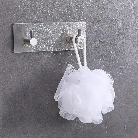 Heavy Duty Adhesive Wall Hooks That Are A Total Game Changer For Bathroom And Kitchen Organization Rust Proof Metal Hangers holding a white loofah.