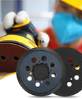 Front view of two 5-inch, 8-hole hook-and-loop sander pads; blue center plate with black backing for DeWalt orbital sanders.
