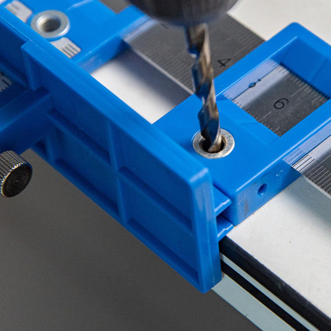 Boss Level Aluminum Punch Locator Drill Guide with blue jig and drill bit positioned for precise cabinet hardware drilling.