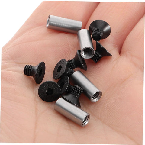 Close-up of four-piece knife handle rivet screw kit with metal sleeves and black fasteners