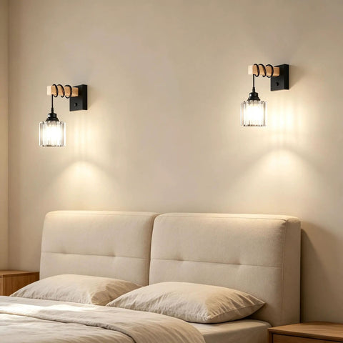 BANGANMA 2-Pack Black Farmhouse Hardwired Wall Sconces Crystal for Bathroom mounted above a bed with beige pillows and wall light.