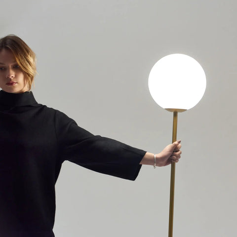Person holding Luna LED Floor Lamp Dope Modern Tall Light For Living Rooms And Home Offices With Frosted Glass Globe Mid Century Style