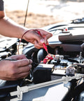 Mechanic working on a car battery with Durable Iron Front Inner And Outer Tie Rods For Golf Carts No Fuss Install Smooth Steering Reliable Ride