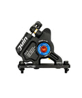 Juin F1-S hybrid hydraulic disc brake caliper, black with blue adjustment dial, front view.