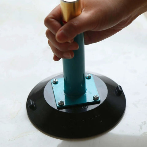 Close-up of Six-Inch Vacuum Suction Cups With Metal Handle in use, showing the brass pump and protective cover, for flat and curved surfaces.