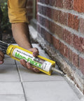 Person applying Top Shelf Textured Caulk Sealant For Mortar Stucco Repair On Brick Stone Concrete Masonry Beige 10 Point 5 Oz Tube.