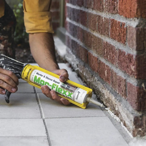 Gray Mortar And Stucco Repair Caulk 3 Pack 10.5 Oz No Hassle Squeeze Tube application on outdoor brick joints.