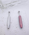 No Fuss Easy Change Piercing Taper Ball Grabber Tool Set in silver and pink, textured handles on a speckled surface.