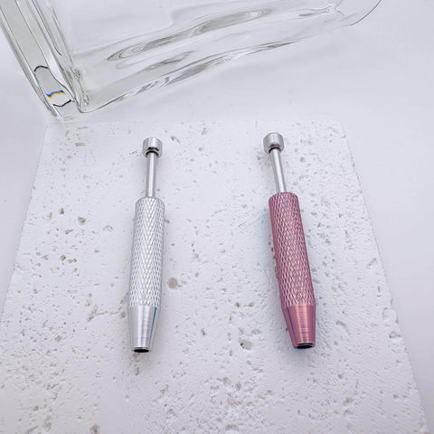 No Fuss Easy Change Piercing Taper Ball Grabber Tool Set in silver and pink, textured handles on a speckled surface.