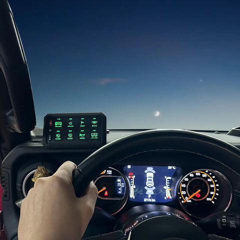 Driver holds wheel with 8 Gang Switch Panel With Wireless Remote And RGB Backlit Multifunction Toggle on dashboard in view.
