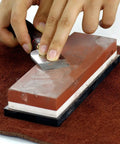 Pro Grade Knife Sharpening Stone Kit With 400 1000 And 3000 8000 Grit Wet Whetstones being used on a knife