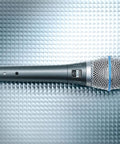 BETA 87A Studio Grade Vocal Microphone With Built In Pop Filter Pro Grade Supercardioid Condenser Mic on textured surface