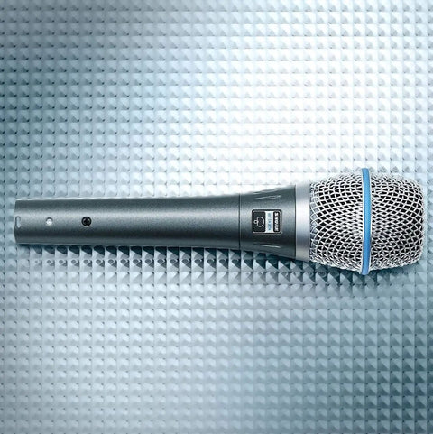 BETA 87A Studio Grade Vocal Microphone With Built In Pop Filter Pro Grade Supercardioid Condenser Mic on textured surface