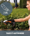 Person using 2 In 1 Cordless Hedge Trimmer And Grass Shear Kit With 4 Inch Grass Blade And 8 Inch Shrub Blade, lightweight design.