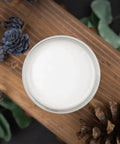 Top view of Sawmill Gravy Chalk Mineral Furniture Paint 32oz Matte Beige Finish in open jar, surrounded by pinecones.