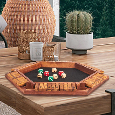 Upgraded Shut The Box Dice Game for 1 to 6 players on wooden board with 16 dice, displayed on table in a cozy home setting.