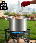 Dual Burner Propane Camping Stove With 200,000 BTU Beast Power in use, boiling water outdoors with pot on black stand