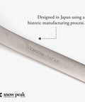 Close-up of Ultra Lightweight Titanium Spork for Outdoors Camping Utensil marked with 'Titanium Japan' engraving.