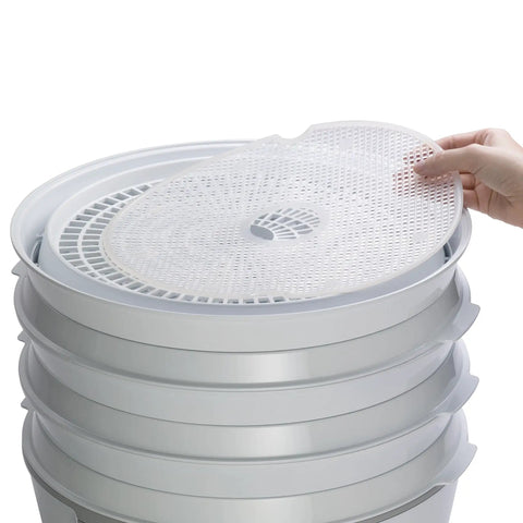Smooth Operator Digital Electric Food Dehydrator With Stackable Trays, hand placing tray on top, ideal for jerky and herbs.